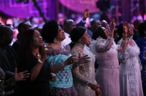 Women sing a song on the Praise Night with Pastor Chris