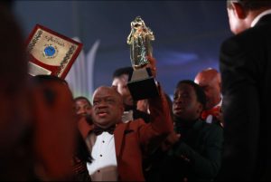 Pastor Pastor Vale Odu-Thomas with a statuette of LoveWorld Awards